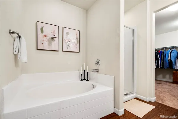 a white bath tub sitting next to a white wall