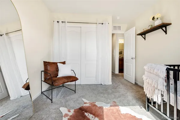a living room with furniture a rug and a wooden floor