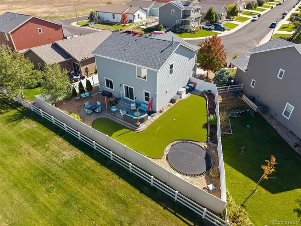 an aerial view of a house with swimming pool and outdoor seating