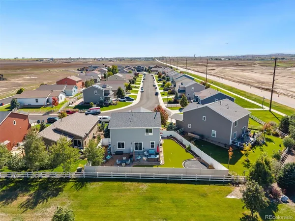 an aerial view of house with yard swimming pool and ocean view