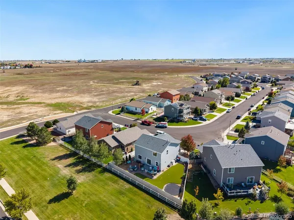 an aerial view of residential houses with outdoor space