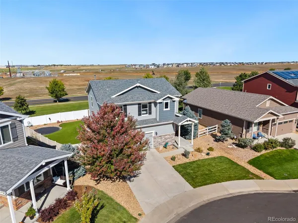 an aerial view of a house with a garden and lake view
