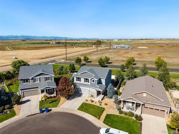 an aerial view of residential houses with outdoor space and ocean view