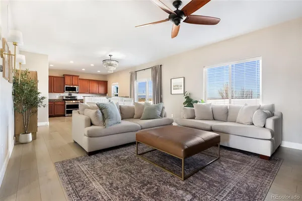 a living room with furniture and kitchen view
