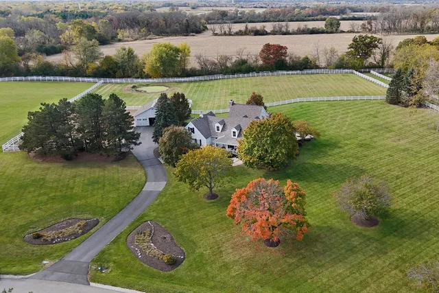 a front view of a house with a yard and potted plants