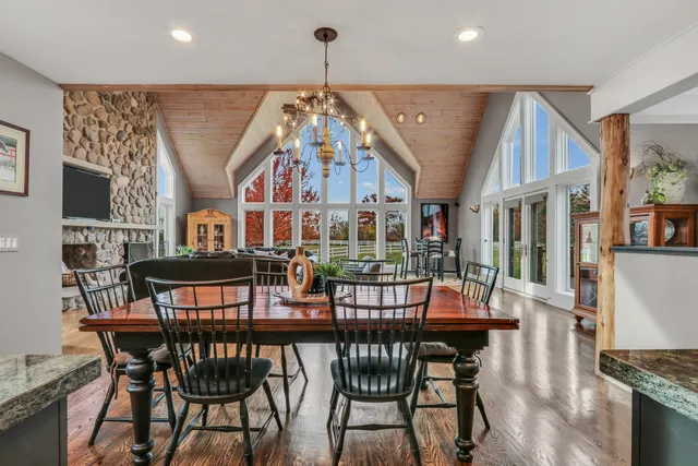 a view of a dining room with furniture a chandelier and wooden floor