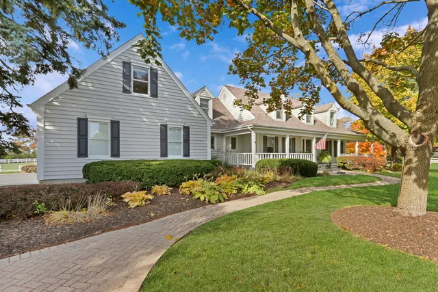 a front view of a house with potted plants