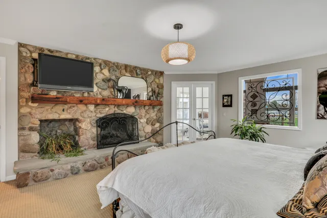 a view of an ocean with boats and trees in the background