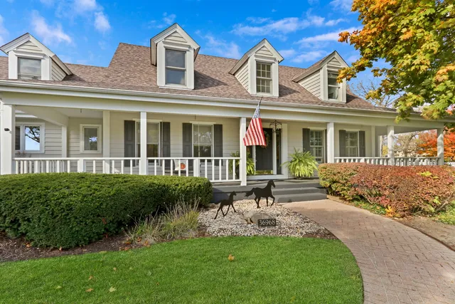 a view of a house with swimming pool and sitting area