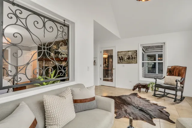 an aerial view of a house with a garden and lake view