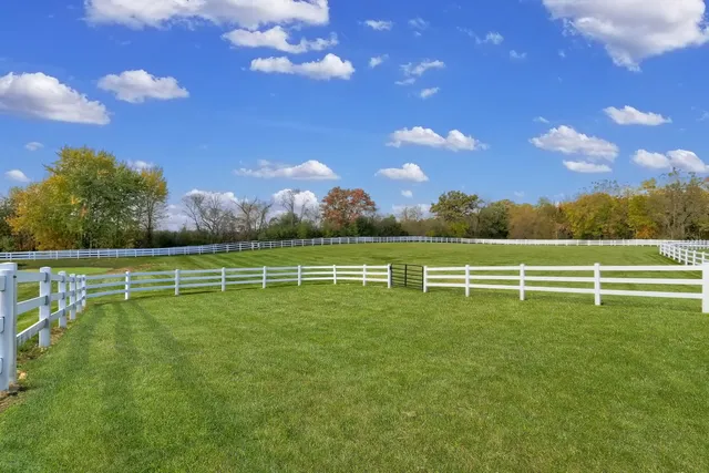 a view of a dining room with furniture and a chandelier