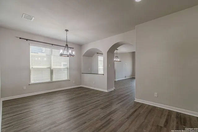 a kitchen with stainless steel appliances granite countertop a sink refrigerator and cabinets