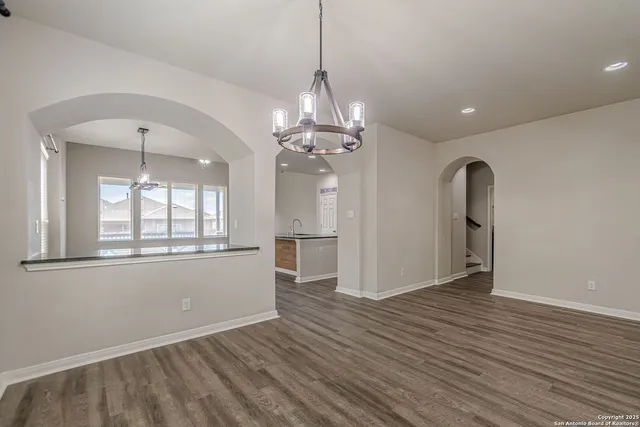 a kitchen with granite countertop white cabinets and stainless steel appliances