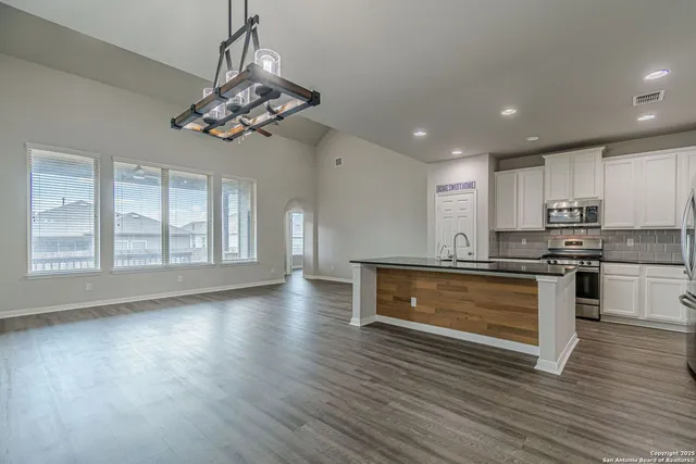 a spacious bathroom with a tub sink and mirror