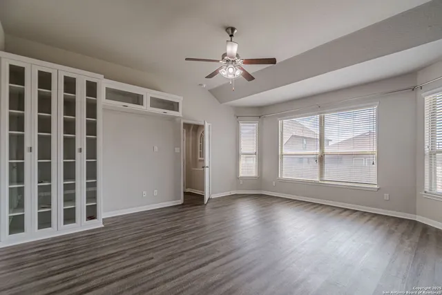 a view of an empty room with wooden floor