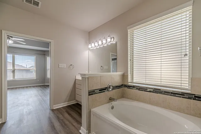 a bathroom with a sink vanity and mirror