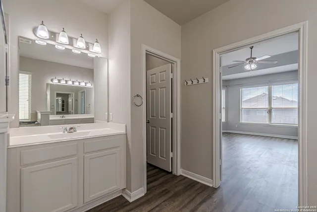 a view of an empty room with a ceiling fan