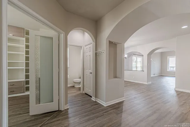 a room with a large window and a wooden floor