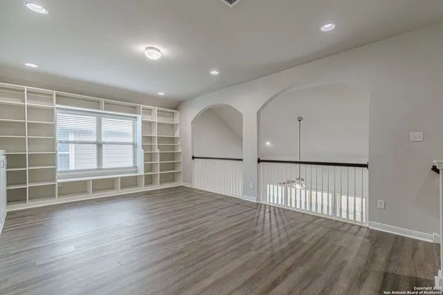 an empty room with windows and closet