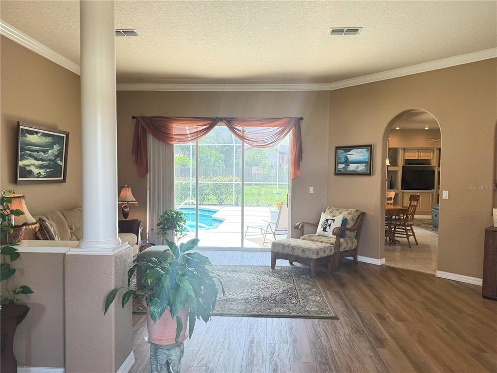 7552 River Country Drive Weeki Wachee, FL 34607 - Photo 11 of 59 a living room with furniture and a large window
