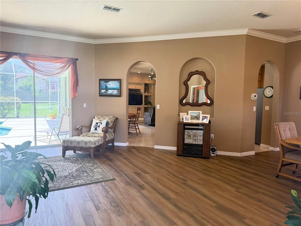 7552 River Country Drive Weeki Wachee, FL 34607 - Photo 12 of 59 a living room with fireplace furniture and a wooden floor
