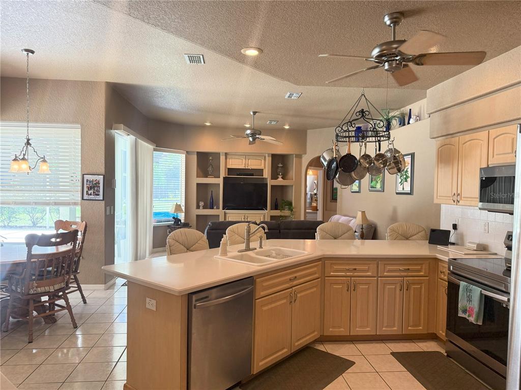 7552 River Country Drive Weeki Wachee, FL 34607 - Photo 20 of 59 a kitchen with a sink stove and cabinets