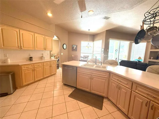a kitchen with a refrigerator a stove a sink and a cabinets