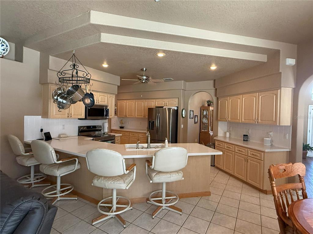 7552 River Country Drive Weeki Wachee, FL 34607 - Photo 25 of 59 a large kitchen with a table and chairs in it