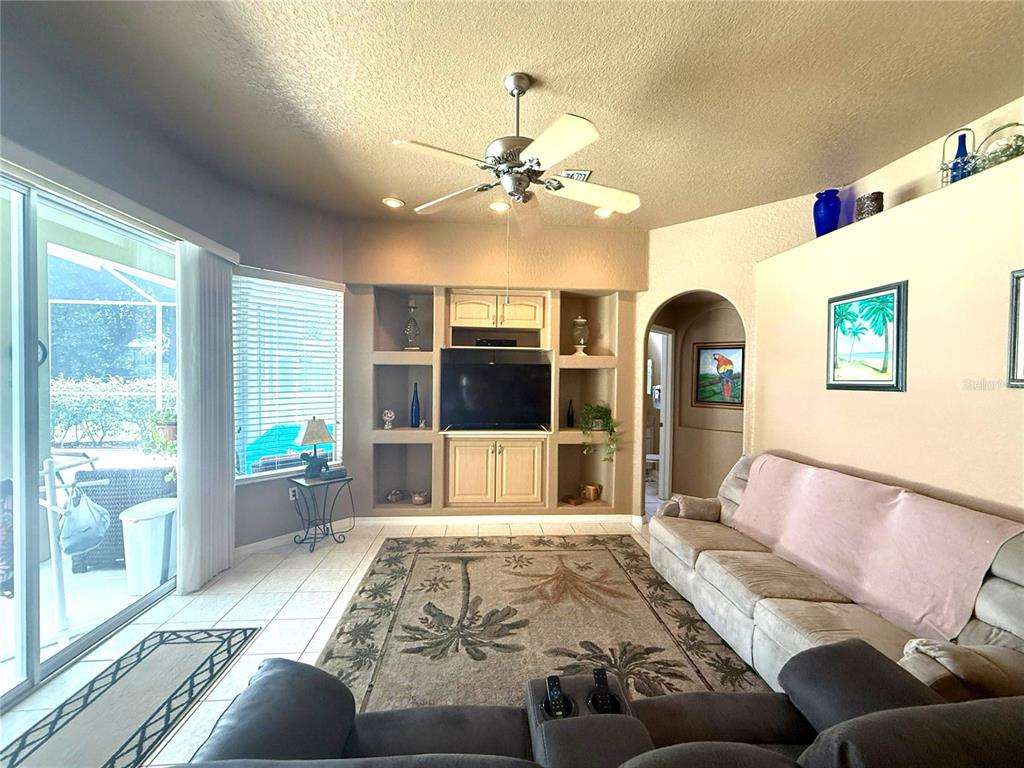 7552 River Country Drive Weeki Wachee, FL 34607 - Photo 26 of 59 a living room with furniture and a flat screen tv