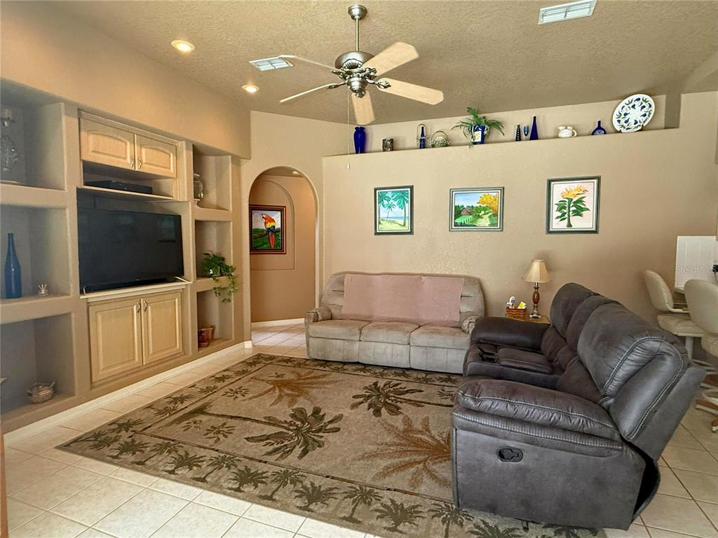 7552 River Country Drive Weeki Wachee, FL 34607 - Photo 27 of 59 a living room with furniture and a flat screen tv