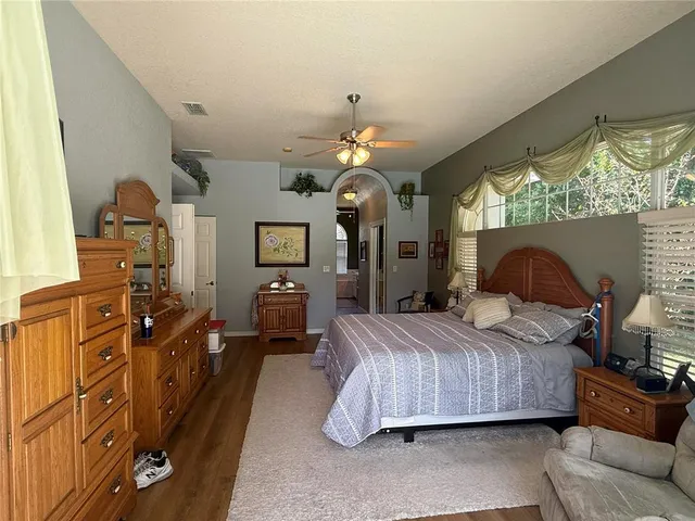 a bathroom with a tub sink vanity and a mirror