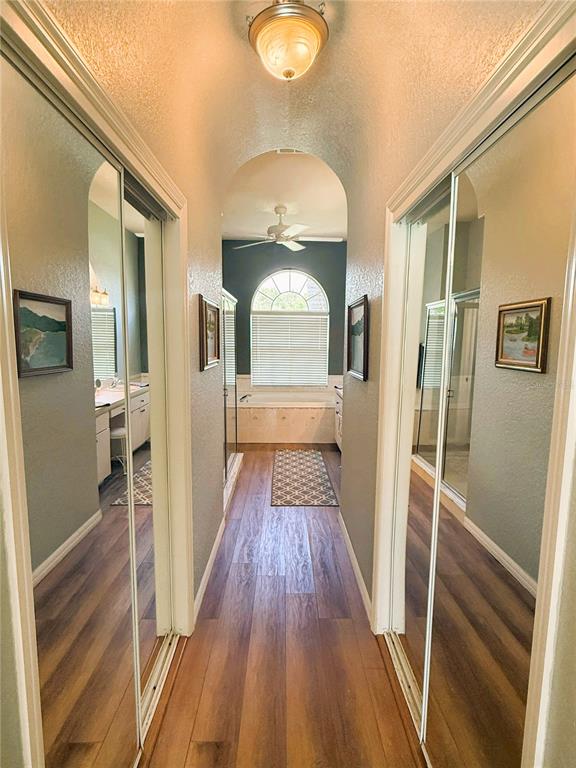 7552 River Country Drive Weeki Wachee, FL 34607 - Photo 33 of 59 a view of a hallway with wooden floor and staircase