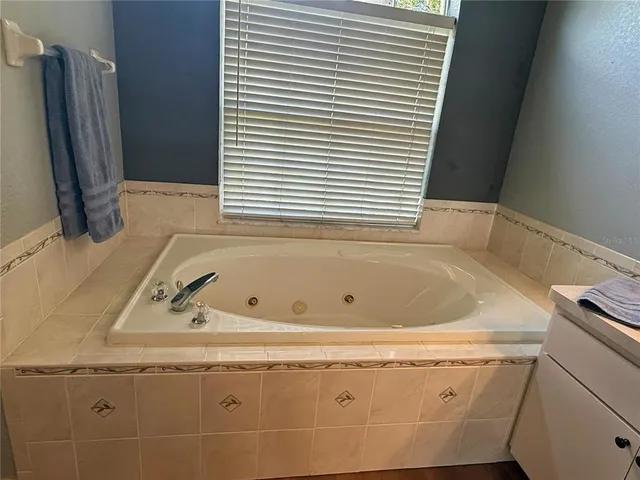 a bathroom with a glass shower door and a mirror