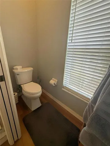 a bathroom with a toilet a sink and a mirror