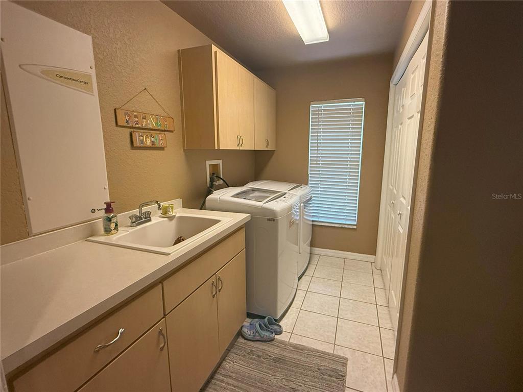 7552 River Country Drive Weeki Wachee, FL 34607 - Photo 44 of 59 a utility room with a sink washer and dryer