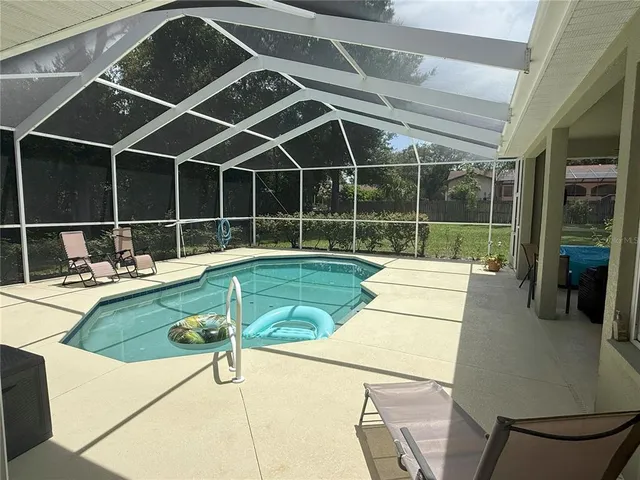 a view of a patio with table and chairs with wooden floor and fence
