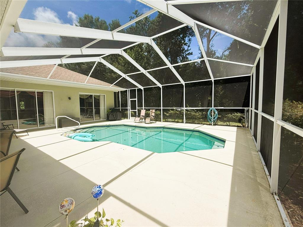 7552 River Country Drive Weeki Wachee, FL 34607 - Photo 50 of 59 a view of a backyard with table and chairs