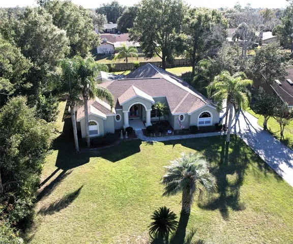 an aerial view of a house with swimming pool and sitting area