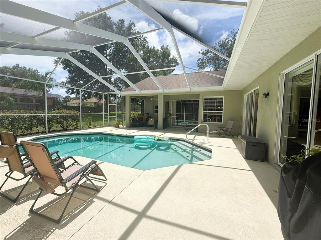 7552 River Country Drive Weeki Wachee, FL 34607 - Photo 52 of 59 a view of a patio with table and chairs with wooden floor and fence