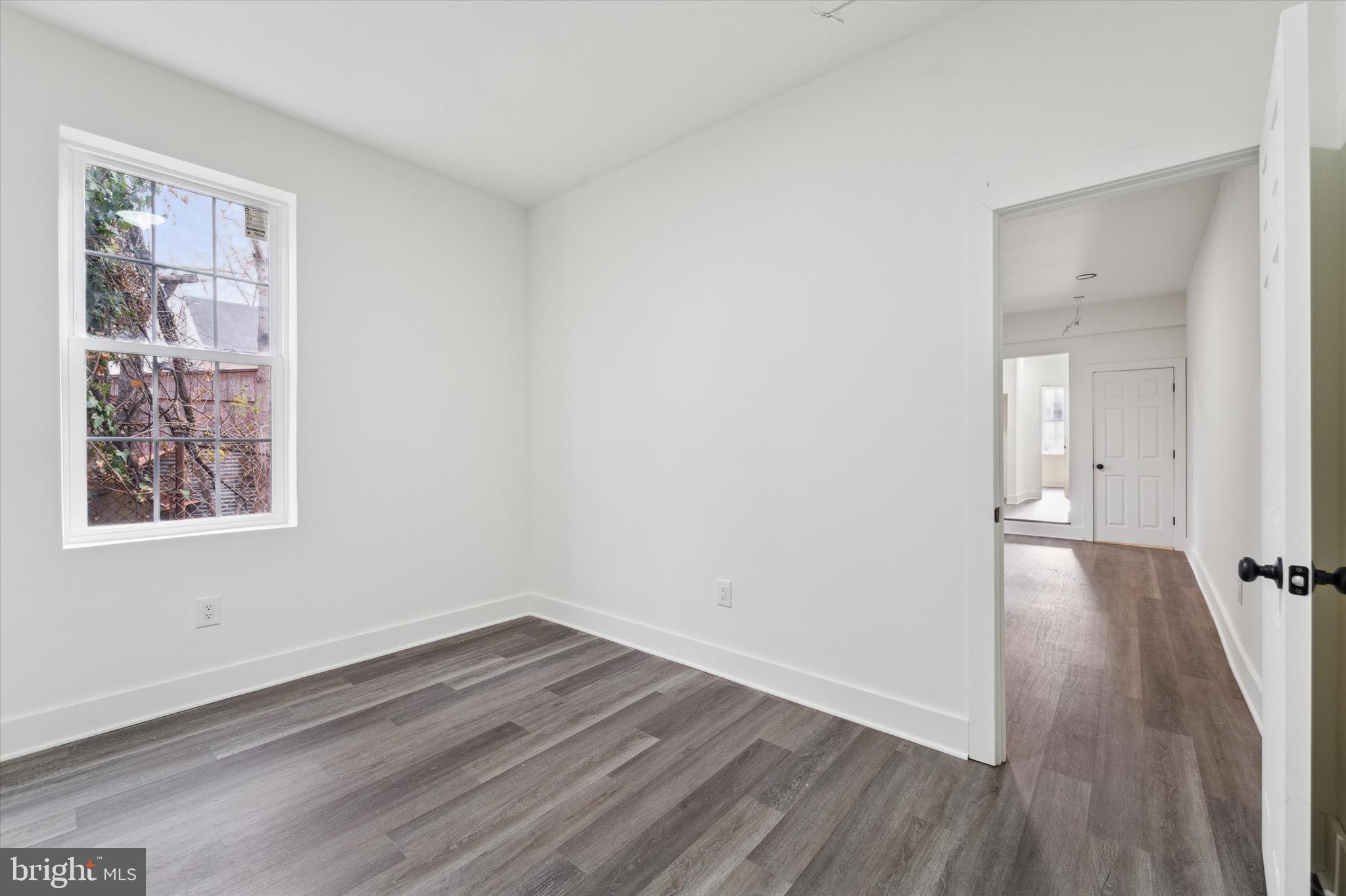 316 East 11th Street Chester, PA 19013 - Photo 13 of 28 a view of a room with wooden floor and windows