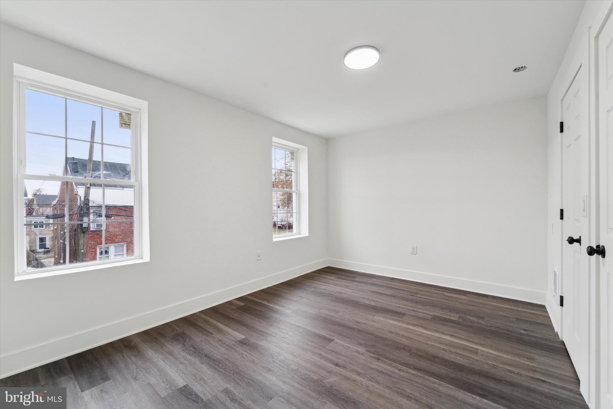 316 East 11th Street Chester, PA 19013 - Photo 16 of 28 a view of an empty room with wooden floor and a window