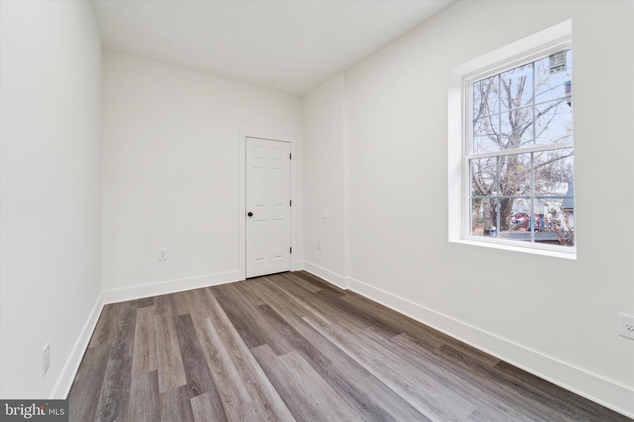 316 East 11th Street Chester, PA 19013 - Photo 17 of 28 a view of a room with wooden floor and window
