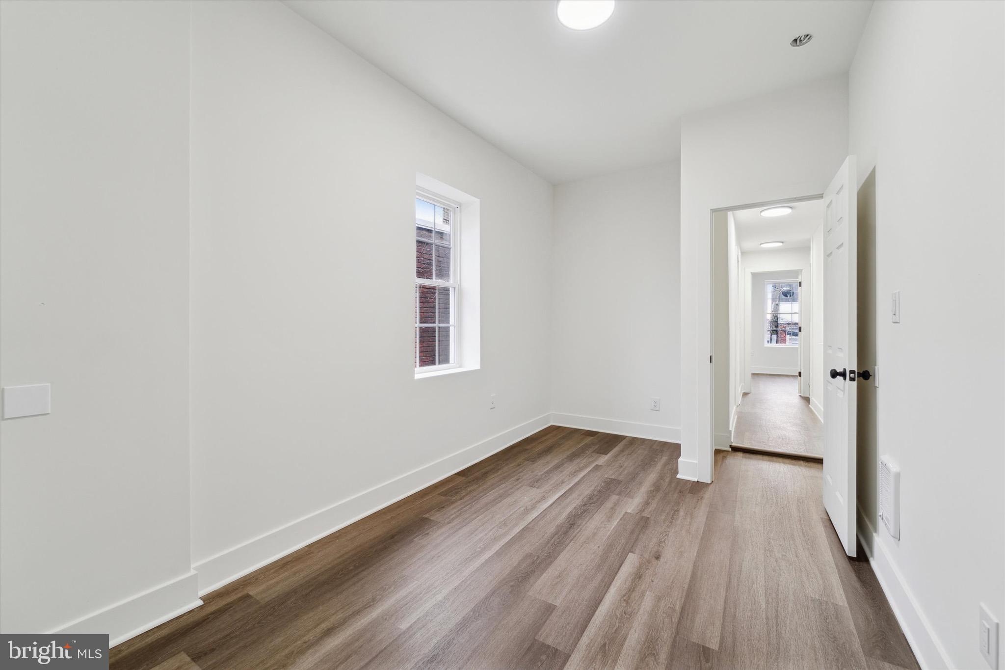316 East 11th Street Chester, PA 19013 - Photo 18 of 28 wooden floor in an empty room with a window