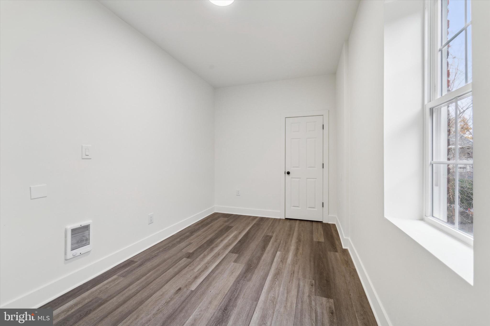 316 East 11th Street Chester, PA 19013 - Photo 19 of 28 a view of a room with wooden floor and white walls