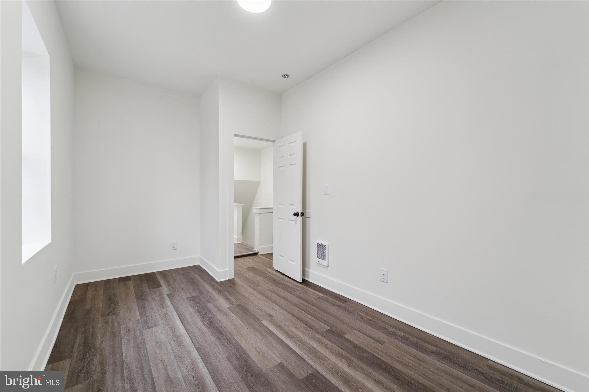 316 East 11th Street Chester, PA 19013 - Photo 20 of 28 a view of a room with wooden floor and white walls