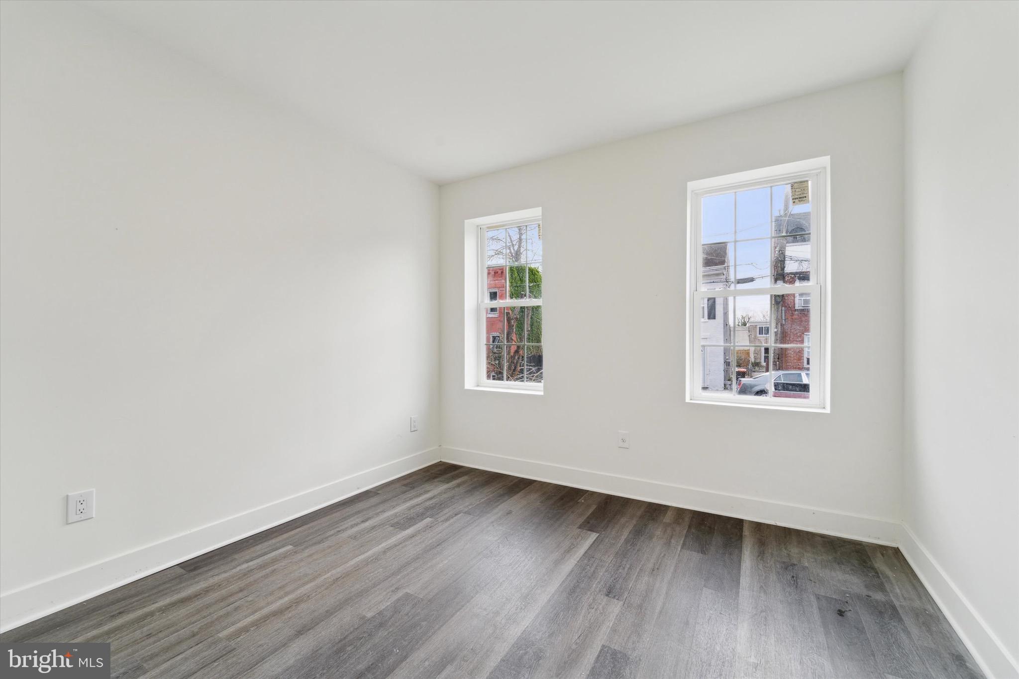 316 East 11th Street Chester, PA 19013 - Photo 2 of 28 a view of an empty room with wooden floor and a window
