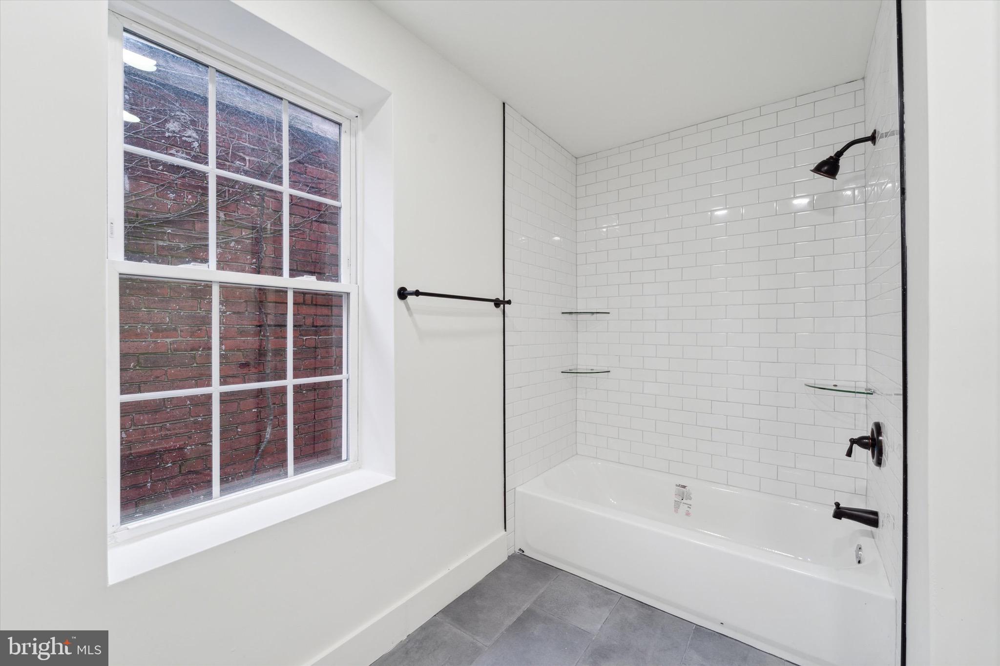 316 East 11th Street Chester, PA 19013 - Photo 23 of 28 a bathroom with a bathtub and a shower