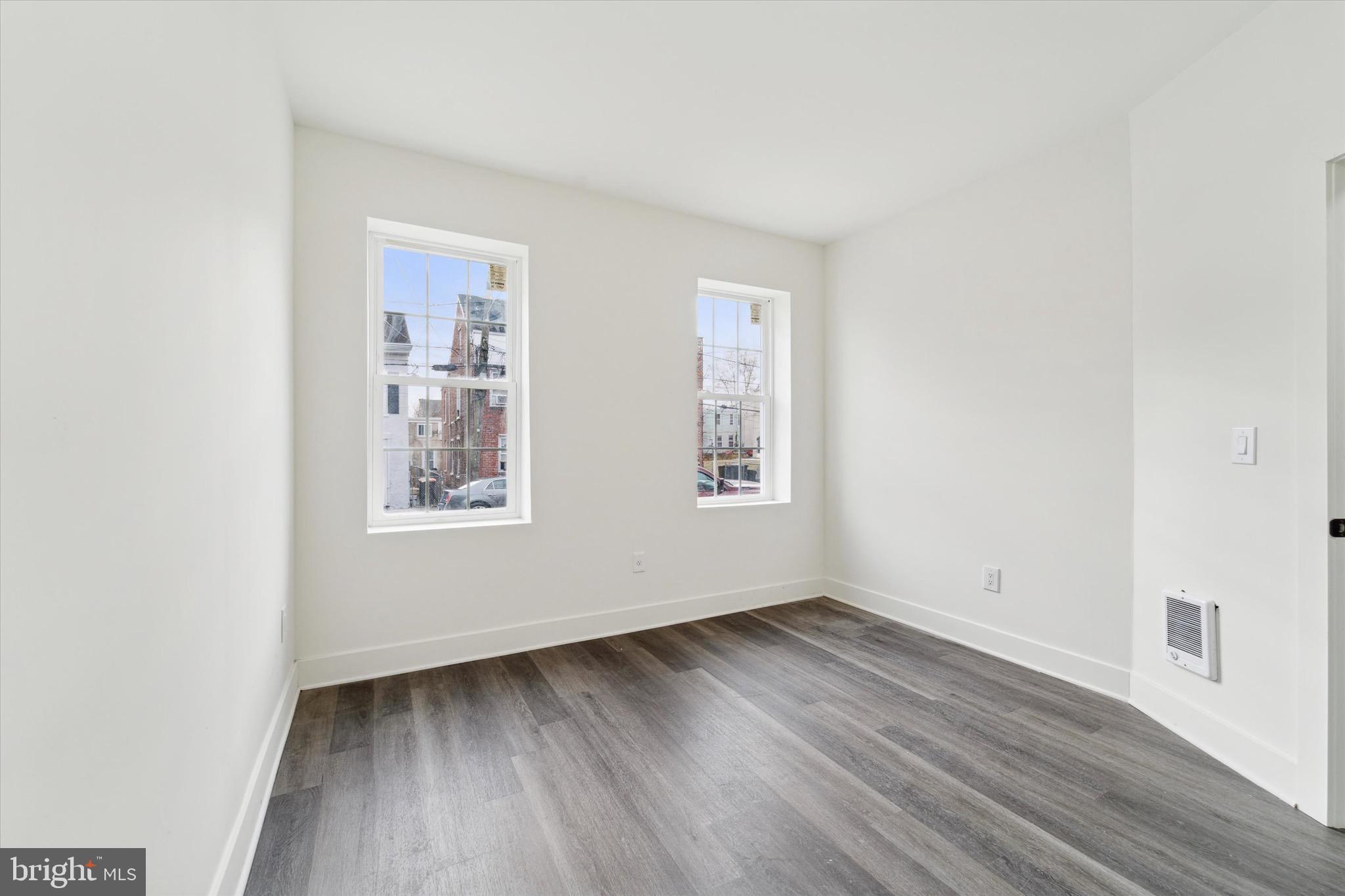 316 East 11th Street Chester, PA 19013 - Photo 3 of 28 an empty room with wooden floor and windows