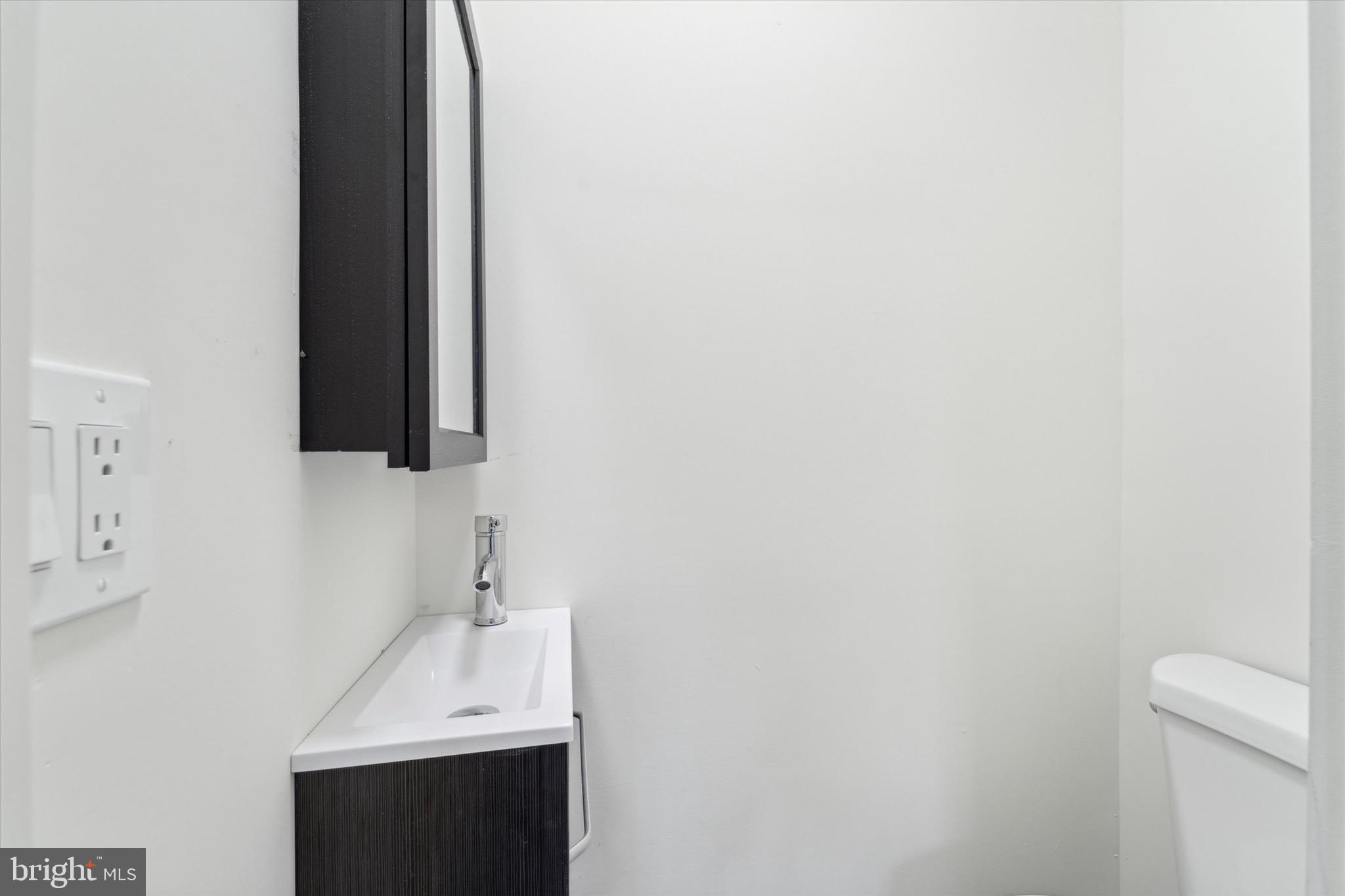 316 East 11th Street Chester, PA 19013 - Photo 6 of 28 a bathroom with a sink and a mirror
