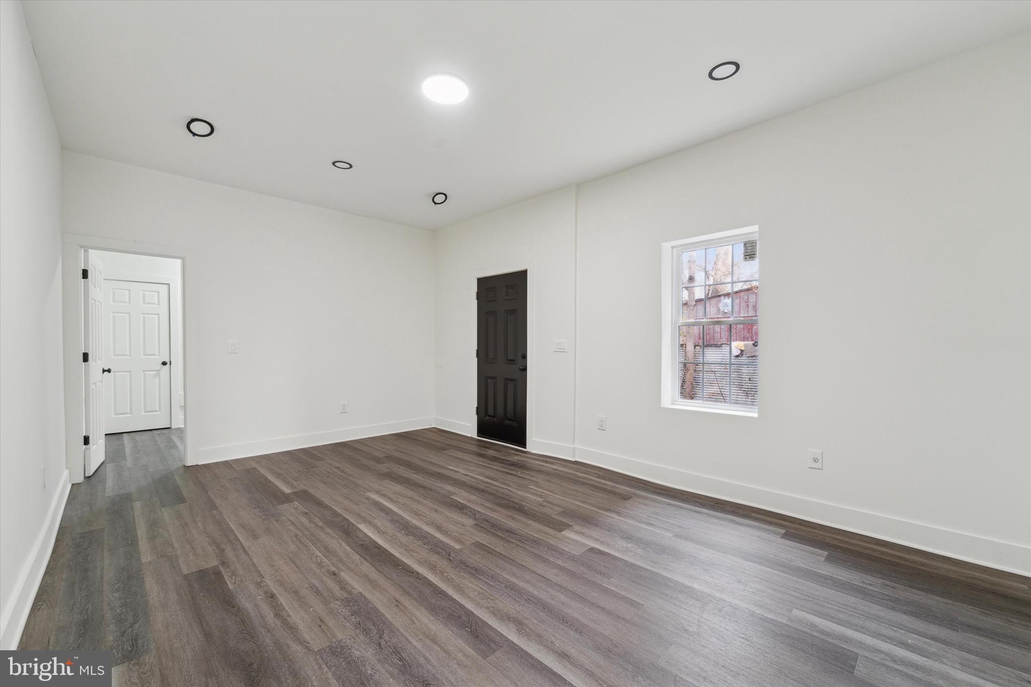 316 East 11th Street Chester, PA 19013 - Photo 7 of 28 a view of an empty room with wooden floor